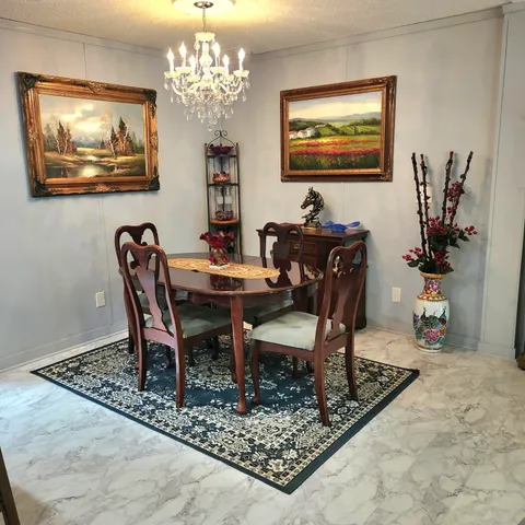 a view of a dining room with furniture wooden floor and a chandelier