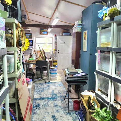 a view of a chair and table in the backyard