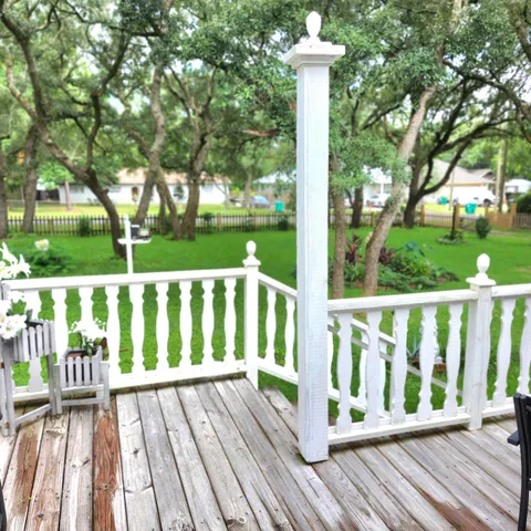 a bedroom with a bed dresser and wooden floor