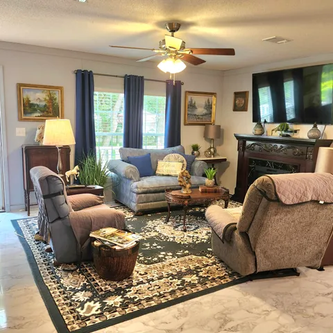 a living room with furniture and a fireplace
