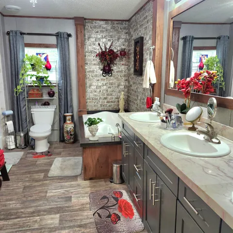 a bathroom with a sink mirror and toilet