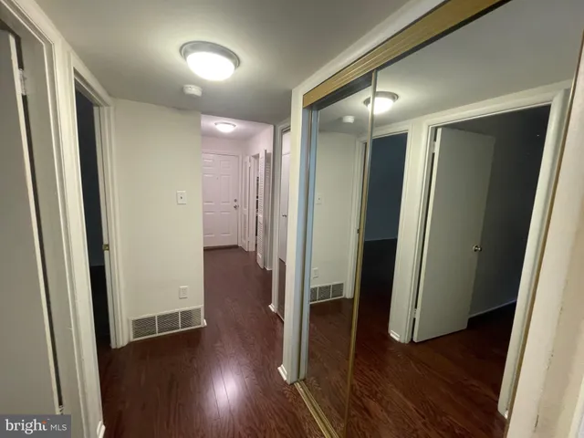 a view of hallway with wooden floor