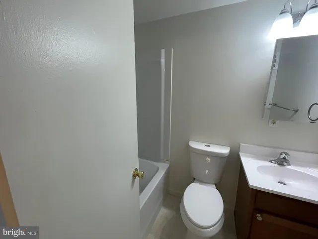 a white toilet sitting next to a bathroom sink