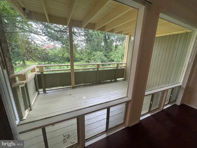 a view of a kitchen with a sink and wooden floor