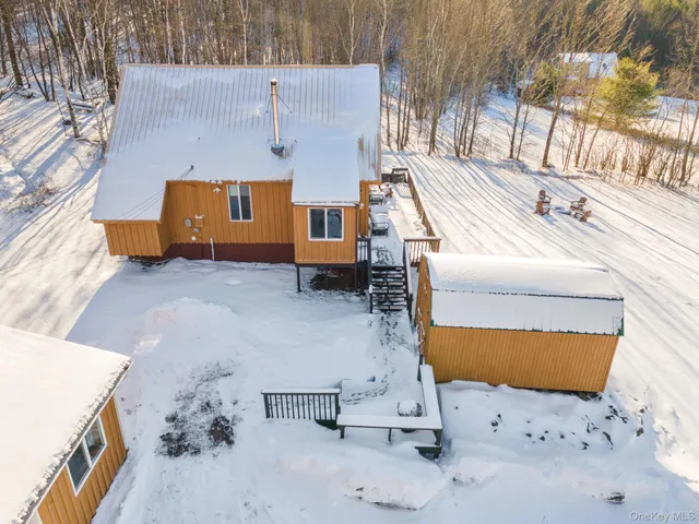 an aerial view of a house with a yard
