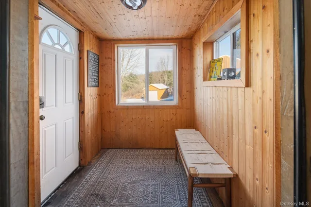 a view of a hallway with windows and stairs