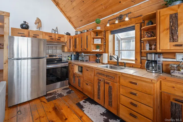 a kitchen with stainless steel appliances a refrigerator and a sink
