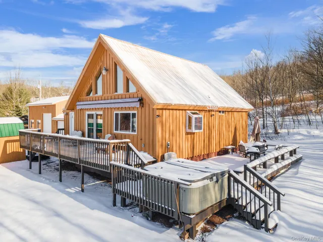 a view of a house with pool and chairs