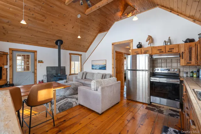 a living room with furniture a fireplace and a table