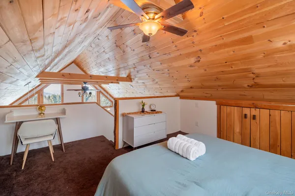 a bedroom with a bed and a chair