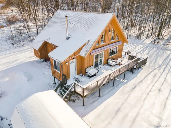 a balcony with couch and wooden fence
