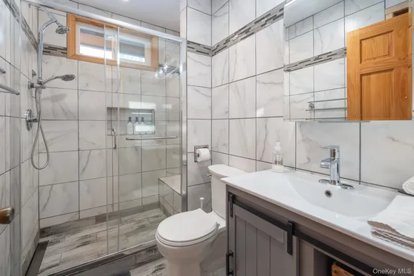 a bathroom with a sink toilet and shower