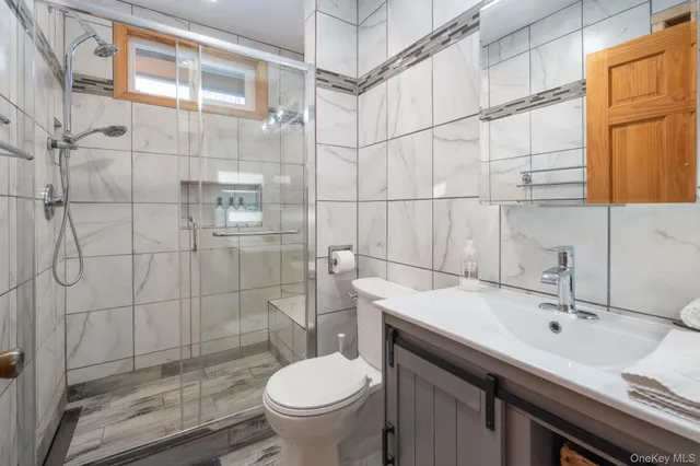 a bathroom with a sink toilet and shower
