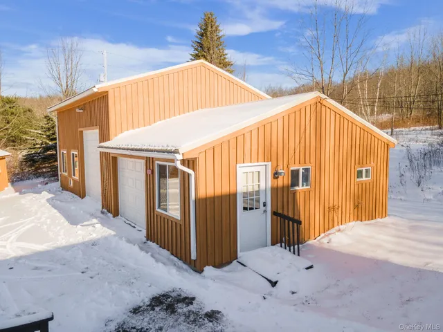 a view of a house with a wooden fence