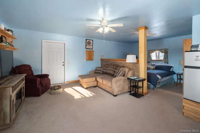 a living room with furniture and a lamp