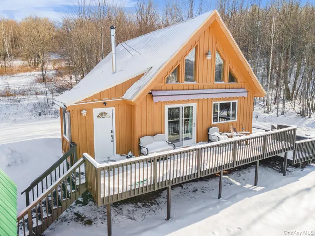 a view of a house with a wooden fence