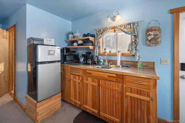 a kitchen with stainless steel appliances granite countertop a refrigerator a stove and a sink