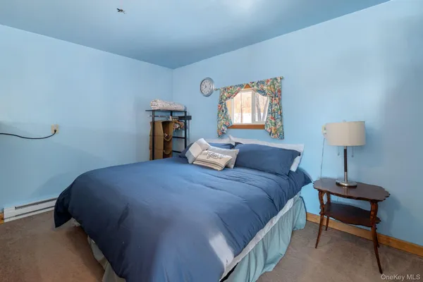 a bedroom with a bed and a lamp