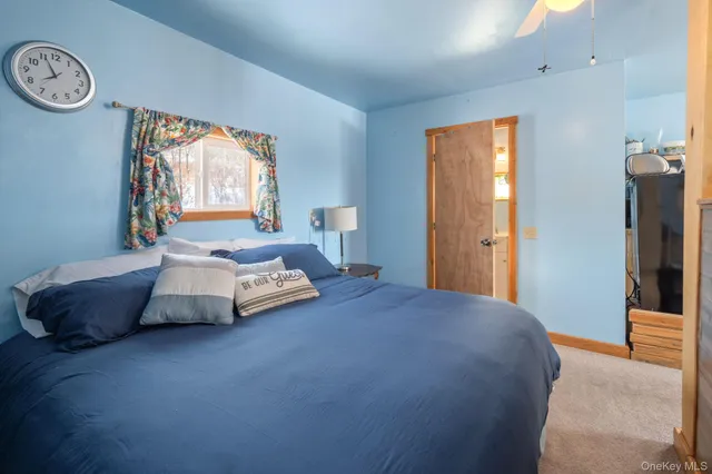 a spacious bedroom with a bed and a window