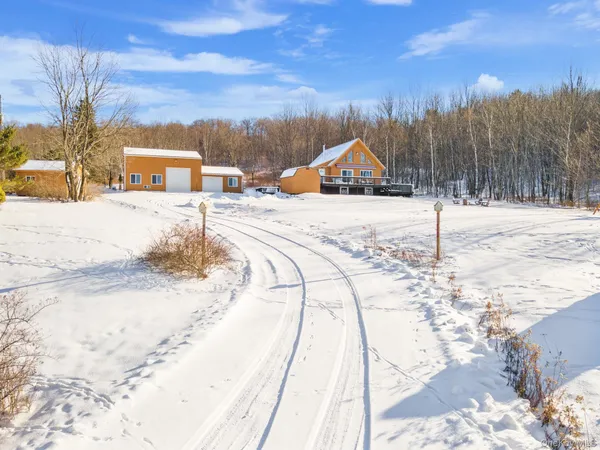 a view of a road with a house in the background