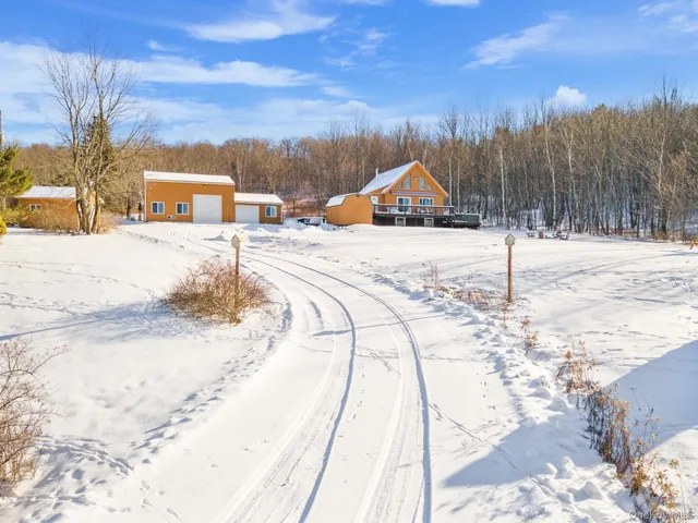 a view of a road with a house in the background