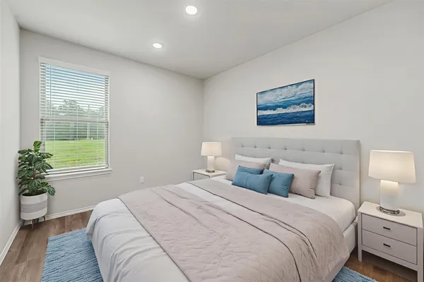 a bedroom with a bed and a potted plant