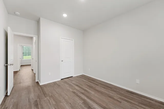 a view of a room with wooden floor