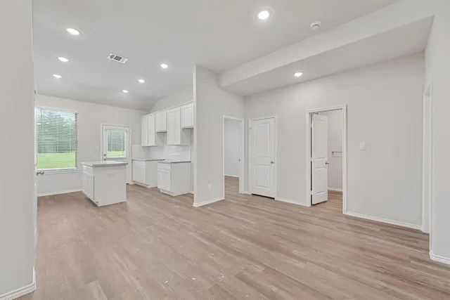 a view of a kitchen with a refrigerator and a sink