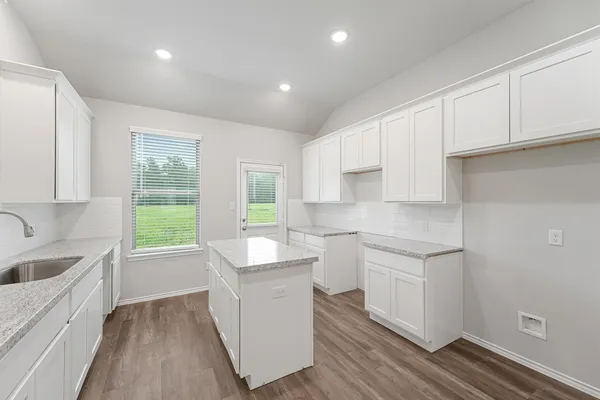 a kitchen with sink cabinets and wooden floor