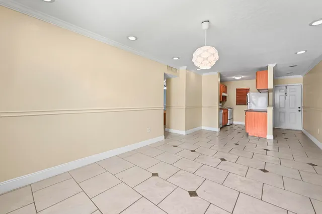 a view of a kitchen with a refrigerator and a stove top oven