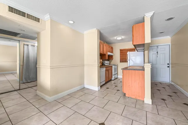 a kitchen with stainless steel appliances granite countertop a refrigerator and a sink