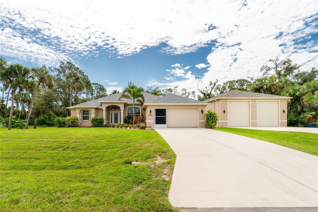 4942 Ariton Road North Port, FL 34288 - Photo 1 of 1 a front view of a house with a yard and garage
