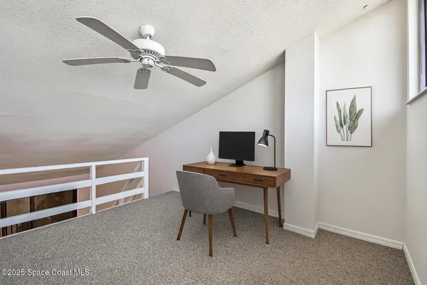 a view of empty room with wooden floor and fireplace