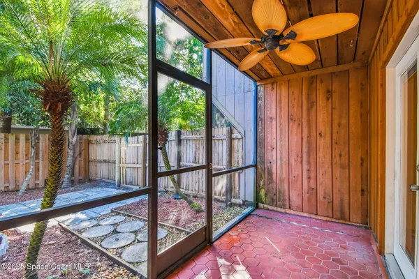 a view of a house with a small yard and wooden fence
