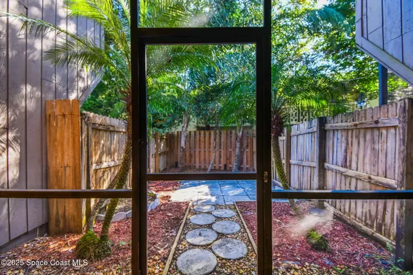 a view of a house with a wooden fence