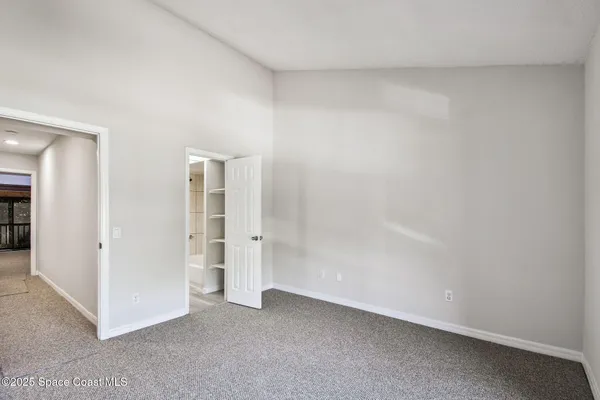 a view of empty room with floor to ceiling window