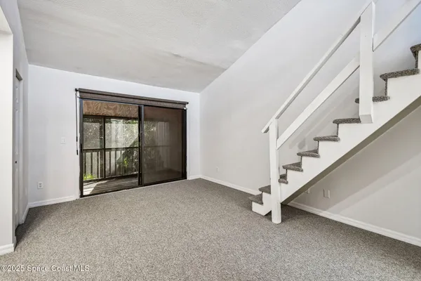 a view of an empty room with a ceiling fan