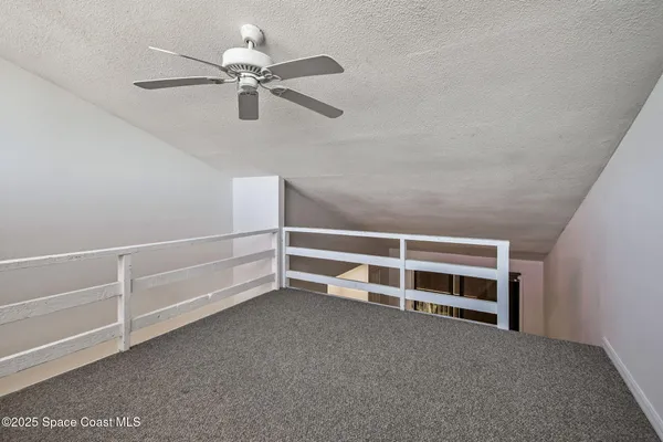 a view of balcony with wooden floor and fence