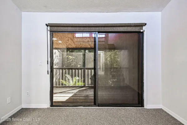 an aerial view of a house with swimming pool and lake view