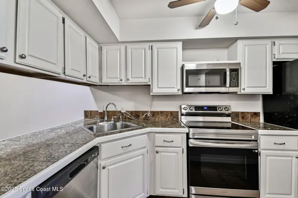 a kitchen with granite countertop a sink and granite top
