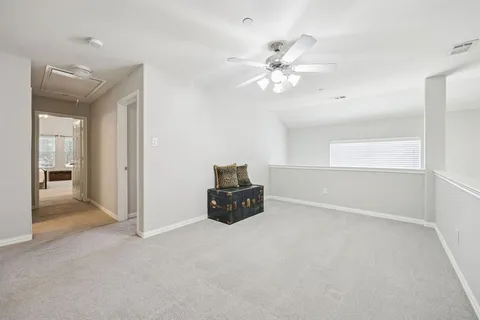 a living room with furniture and a ceiling fan