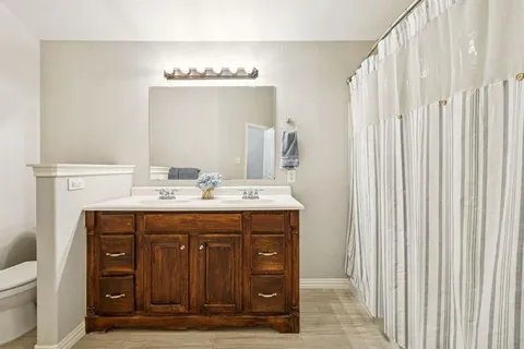 a bathroom with a double vanity sink and a mirror