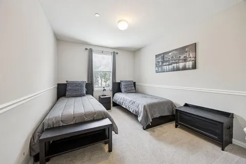 a bedroom with two beds and a couch