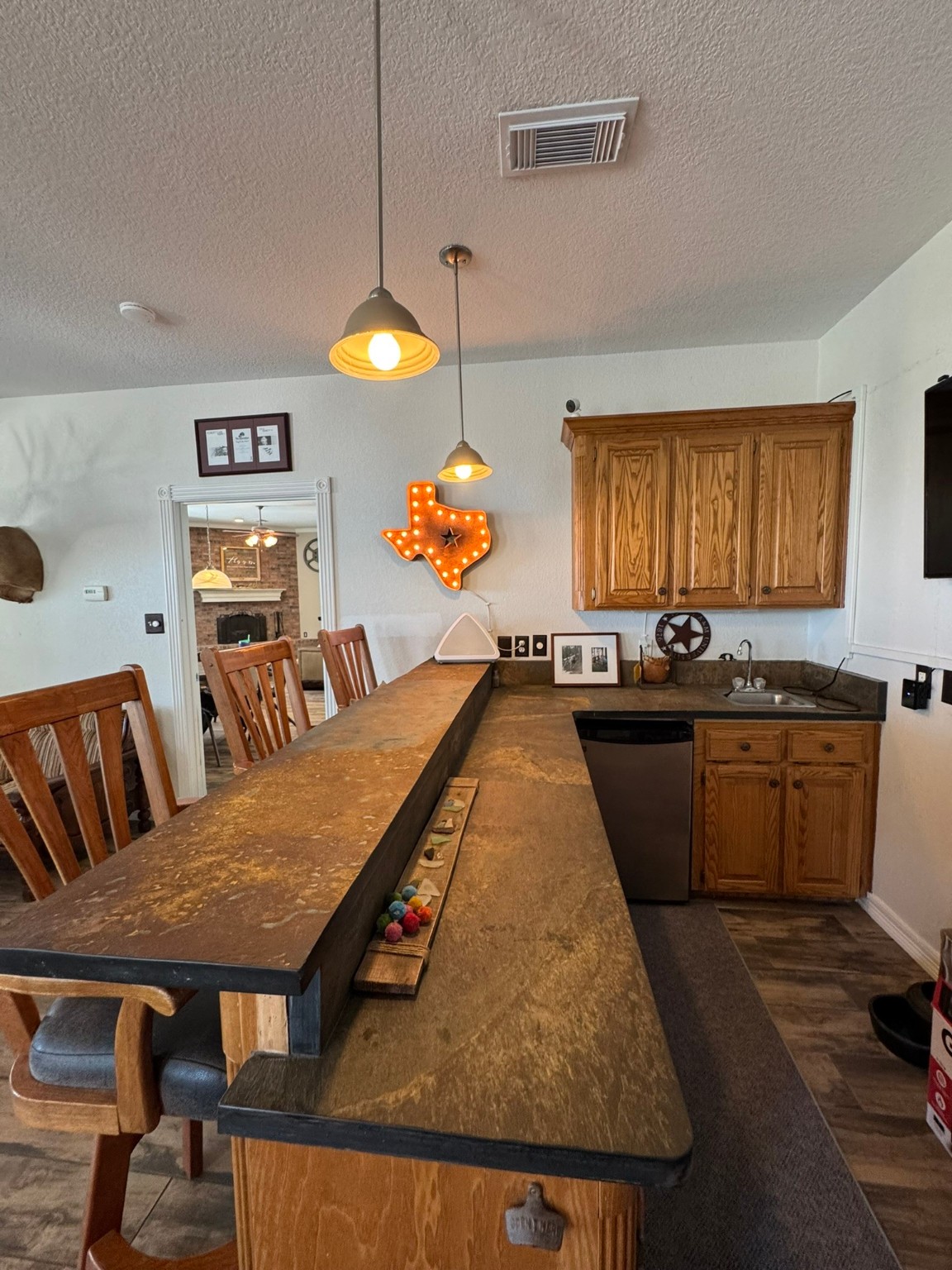 814 Sunset Trail Angleton, TX 77515 - Photo 14 of 26 a kitchen with sink refrigerator dining table and chairs