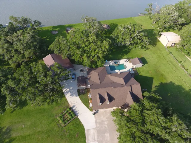 an aerial view of a house with a yard