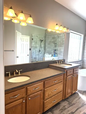 a bathroom with a sink double vanity and a mirror