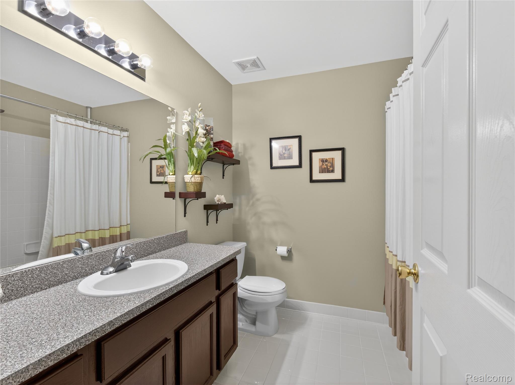 1834 Flagstone Circle, Unit 37 Rochester, MI 48307 - Photo 18 of 31 Bathroom with vanity, curtained shower, and light tile patterned floors