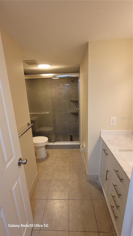 12025 Proctor Loop, Unit 1 New Port Richey, FL 34654 - Photo 6 of 11 a bathroom with a granite countertop toilet and a sink