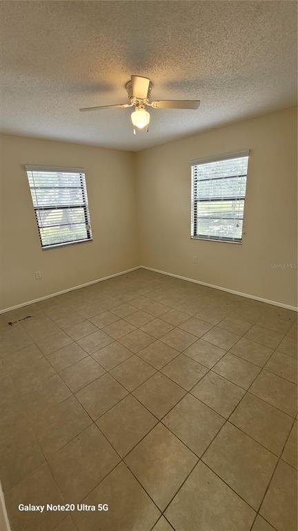 12025 Proctor Loop, Unit 1 New Port Richey, FL 34654 - Photo 7 of 11 en empty room with windows