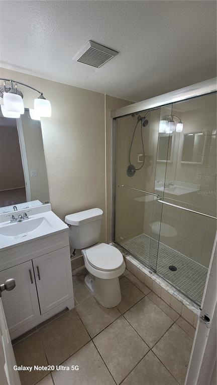 12025 Proctor Loop, Unit 1 New Port Richey, FL 34654 - Photo 9 of 11 a bathroom with a toilet sink and shower